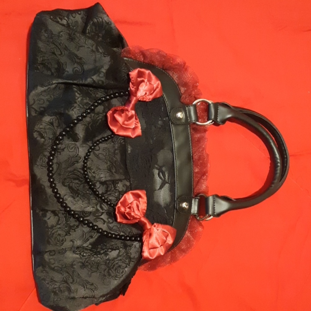 Black skull purse with burgundy bows and lace